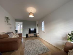 a living room with a couch and a tv at Modern Home Birtley in Birtley