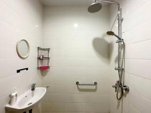 a white bathroom with a sink and a shower at Villa Blue Saphire Sanur Mansion Bali in Denpasar +20 photos