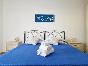 A bed or beds in a room at Le Melodie - Appartamenti con spazi esterni privati a Sos Alinos