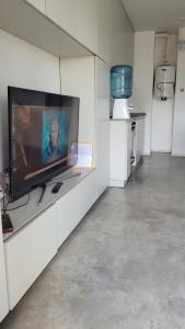 uma sala de estar com uma grande televisão numa parede branca em Pleno céntrico Gualeguaychú em Gualeguaychú