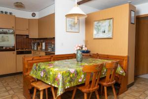 a kitchen with a table with a vase of flowers on it at Pic Chaussy A2 in Les Mosses