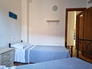 A bed or beds in a room at Le Melodie - Appartamenti con spazi esterni privati a Sos Alinos