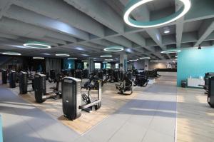 a gym with rows of exercise bikes and machines at VitaLounge Sports & Spa Hotel in Gelsenkirchen