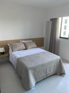 una camera da letto con un grande letto e un pavimento bianco di Makia Beach Experience - D 202 a Porto De Galinhas