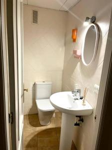 a white bathroom with a toilet and a sink at Bonito y elegante apartamento en Valencia Centro in Valencia