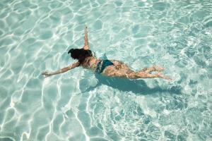 Une femme se couche dans l'eau dans l'établissement Agriturismo Panacea, à Santa Cesarea Terme