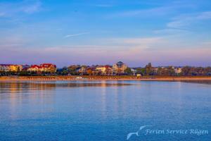 a large body of water with buildings in the background at Ferienhaus Ivory in Binz