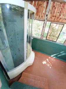 a bathroom with a shower with a toilet in it at Hostal Principio Tayrona in Calabazo