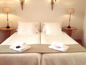 a bedroom with two beds with towels on them at Appartements 7 Florian in Cannes