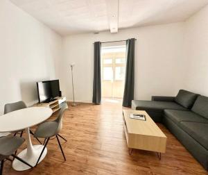 a living room with a couch and a table at Central and modern Valletta flat in Valletta