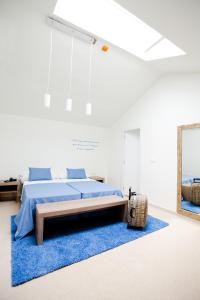 a bedroom with a bed and a blue rug at Boutique Isla Tabarca in Tabarca