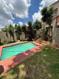 a swimming pool in the yard of a house at An elegant stay away from home in Johannesburg