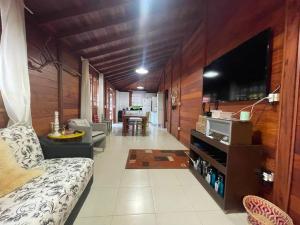 a living room with a couch and a flat screen tv at Cabana Exclusiva: Recarregue suas Energias in Camboriú