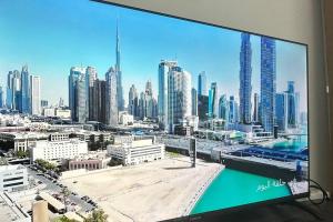 a television screen with a view of a city at شقة في الشارقة in Sharjah