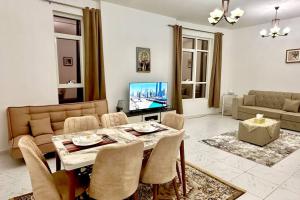 a living room with a table and a television at شقة في الشارقة in Sharjah