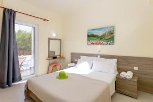 a bedroom with a bed and a window at Eden Beach Hotel in Agia Marina Nea Kydonias +127 photos