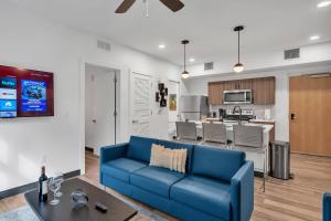 a living room with a blue couch and a kitchen at The Well 306 in Zephyrhills