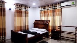 sypialnia z łóżkiem w pokoju z zasłonami w obiekcie Spill View Villa w mieście Minneriya