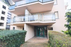 a building with a balcony and a door at Very nice T3 at 3 min from the beach St Enogat in Dinard