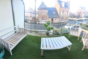 a balcony with three benches and a view of a building at Very nice T3 at 3 min from the beach St Enogat in Dinard