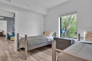two beds in a room with a window at The Well 210 in Zephyrhills +38 photos