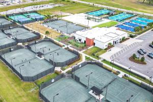 an overhead view of four tennis courts in a park at The Well 210 in Zephyrhills