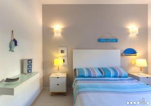 a bedroom with a bed and two lamps and a tv at VH CostaBlanca - SANDRINE in Benitachell +26 photos