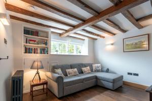a living room with a couch and a window at SandiComplex - 2 properties joined by a garden gate in Sandwich