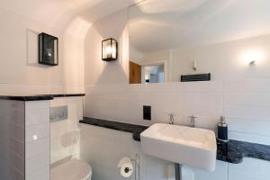 a white bathroom with a sink and a toilet at SandiComplex - 2 properties joined by a garden gate in Sandwich +50 photos
