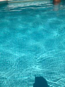 a reflection of a person in a swimming pool at Masseria Battaglini in Martina Franca