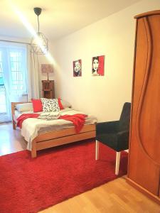 a bedroom with a bed and a red rug at Apartament Trzy Sypialnie Stare Miasto in Elblag