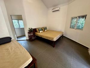 a bedroom with a bed in a room at A Maze Inn Cottage in Phumĭ Chroŭy Svay