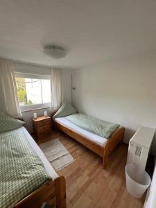 1 Schlafzimmer mit 2 Betten und einem Fenster in der Unterkunft Ferienhaus Konze in Hilchenbach