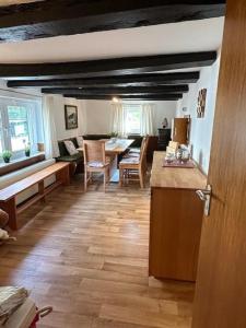 a kitchen and living room with a table and chairs at Ferienhaus Konze in Hilchenbach