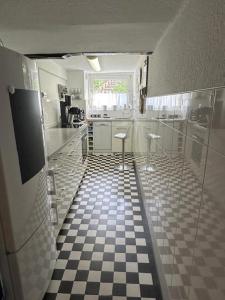 a bathroom with a black and white checkered floor at Ferienhaus Konze in Hilchenbach