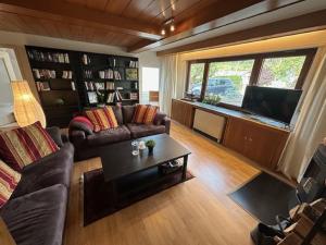 a living room with a couch and a tv at Ferienhaus Konze in Hilchenbach