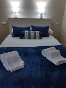 a large bed with towels on top of it at Malecón Guardes in A Guarda