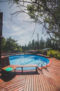 a swimming pool with a bench on a wooden deck at Teniqua Treetops in Sedgefield