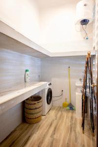 a laundry room with a washer and dryer under a staircase at RoRi Private Luxury Villas in Bwejuu