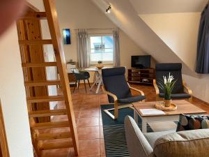 a living room with two chairs and a table at Ferienhäuser Liethmann Haus 3 W2 in Timmendorf