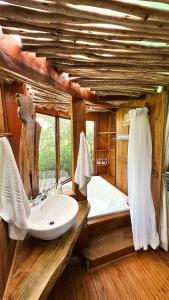 a bathroom with a sink and a bath tub at Teniqua Treetops in Sedgefield
