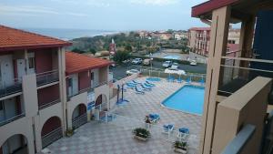 a view of a swimming pool from a balcony of a hotel at Duplex vue Océan- Piscine-Plage à pied in Anglet