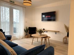 a living room with a couch and a table at 23 Coastal Comfort in Millom