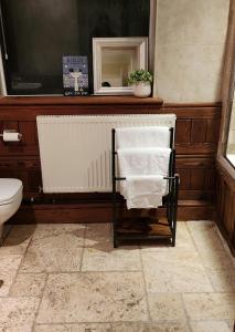 a towel rack in a bathroom with a toilet at Large 2 Bed Holiday Let in Central Ystradgynlais in Ystradgynlais
