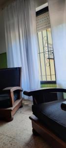 a room with two beds and a window at Casa de campo frente al río Colorado in Río Colorado
