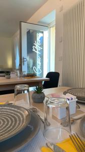 a table with plates and glasses on top of it at Casa Pitem in Nago-Torbole