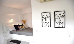 two pictures of a bedroom with a bed at Amelia in Kavoúsion