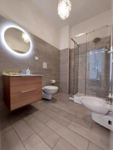a bathroom with a sink and a toilet and a shower at Moonlight Sorrento Studios in Sorrento
