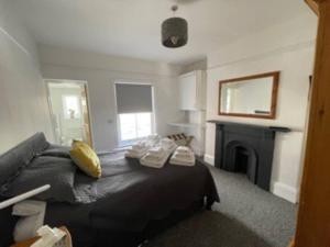 1 dormitorio con cama negra y chimenea en BOURNECOAST: MODERN NEAR TOWN CENTRE/BEACH -FM6142, en Bournemouth