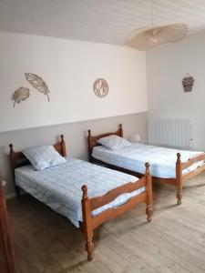 2 Betten in einem Zimmer mit in der Unterkunft La Maison des Rosiers in Manhac